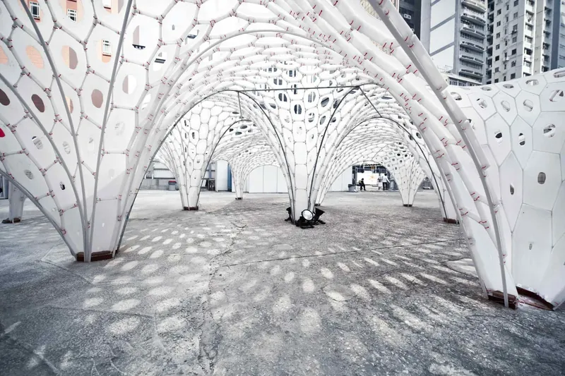 Shell Star, Hong Kong: white cellular vaults lit at night on an open lot